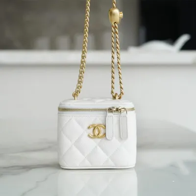 Chanel small gold ball makeup bag